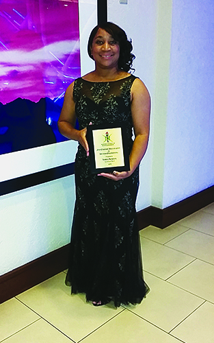 Terita Norton, proud recipient of the 21st Century Trailblazers in Systems Engineering Award poses with plaque