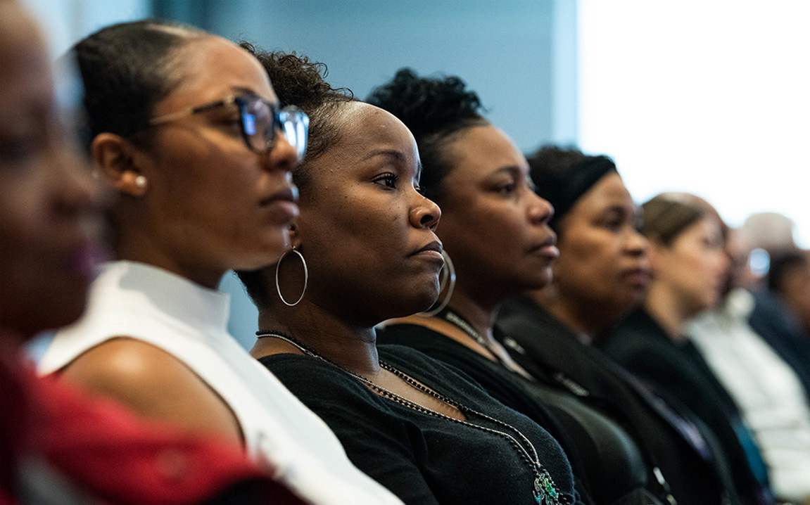 Picture of a group of black women listening to a speech