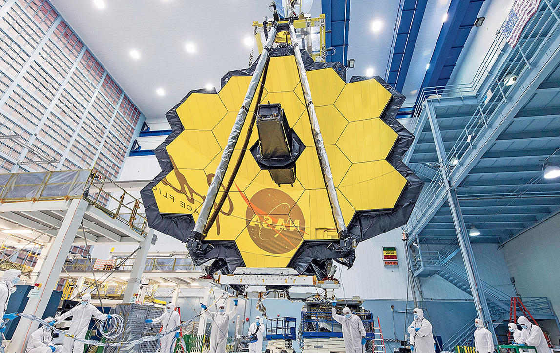 Person scanning vacuum chamber with tablet