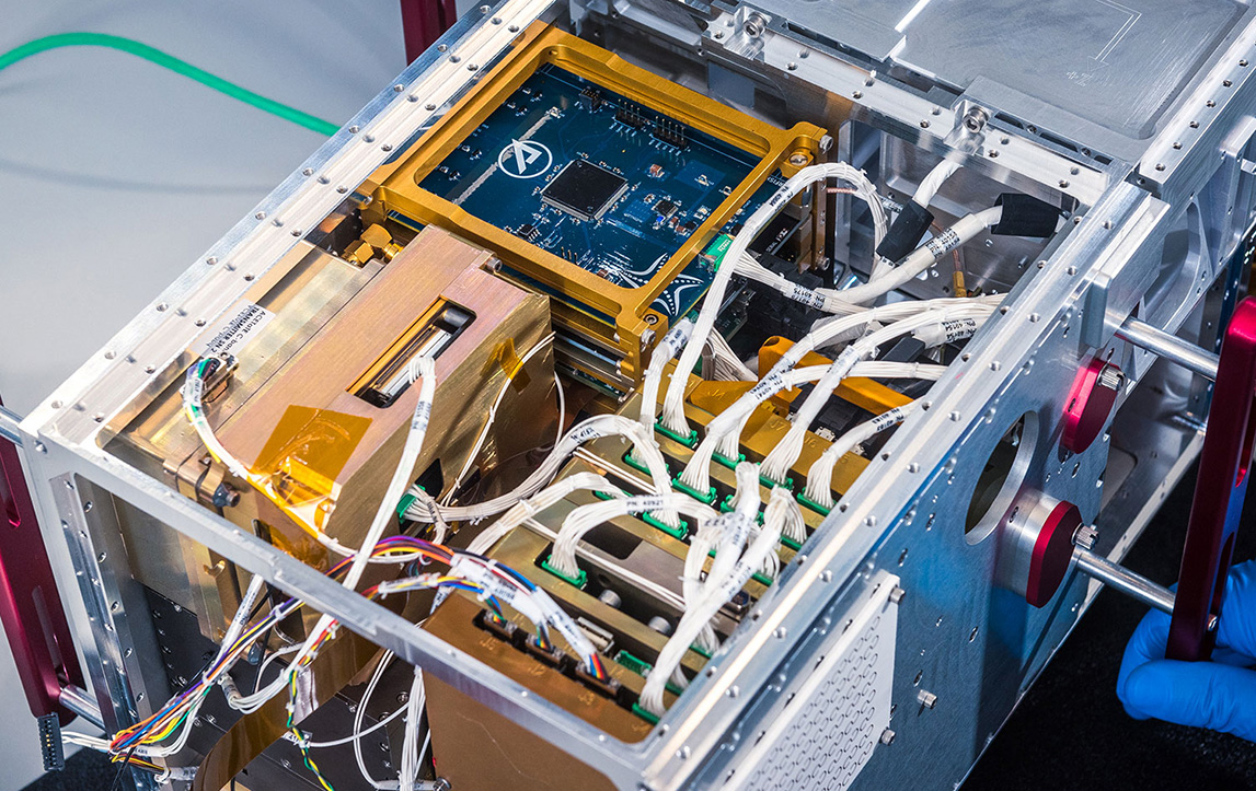 Person scanning vacuum chamber with tablet