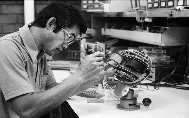 Sam Imamoto assembles prototype electronics for a sheath electric fields experiment flown on the SCATHA satellite.