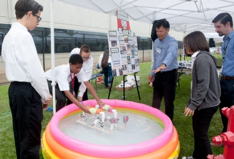 Kids doing a science experiment in a small pool