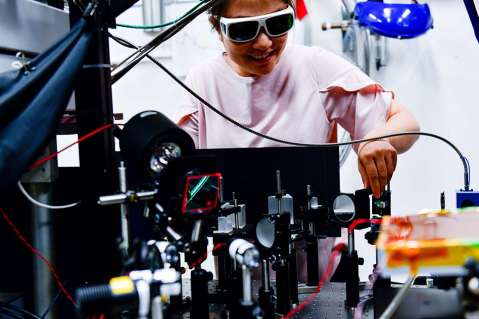 Woman sets up laser equipment