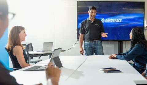 Aerospace employees in a meeting.