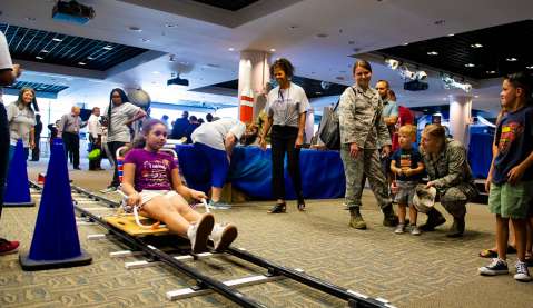 Children participate in Aerospace-hosted activities at the SMC Open House