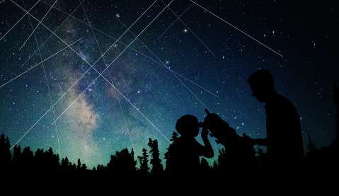 Illustration of streaks of light from satellites across the night sky