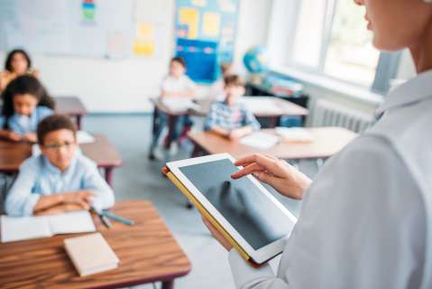 Teacher with ipad in elementary class