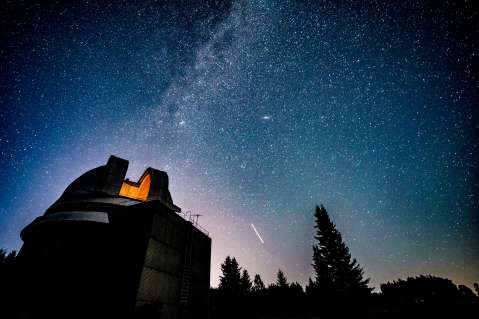 Milky Way galaxy over observatory Adobe image