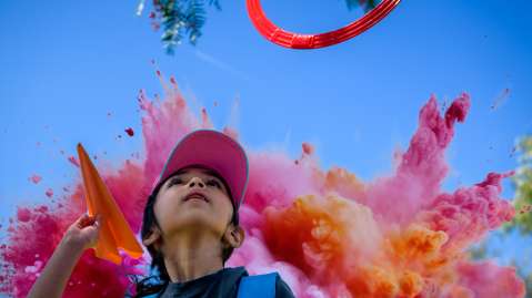 Picture of kid throwing a paper airplane