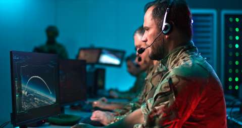 Military commander using computer during conflict