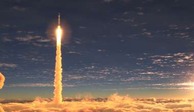 Rocket launch above clouds at sunset