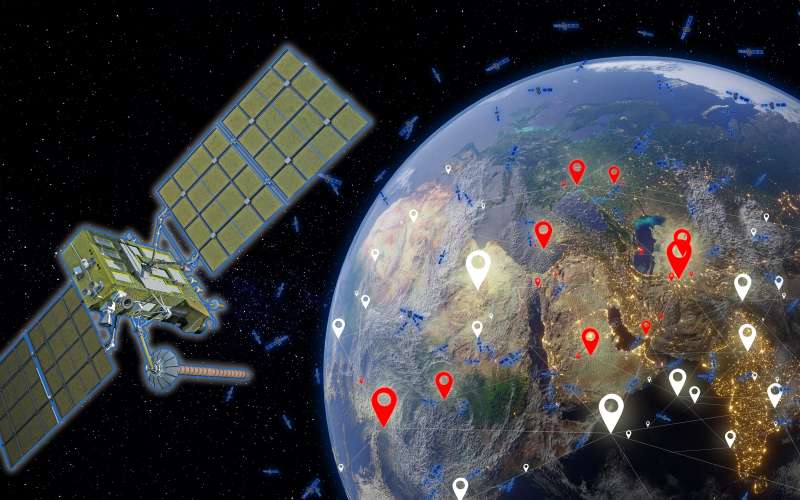 Satellite orbiting Earth with smaller satellites in the backdrop.