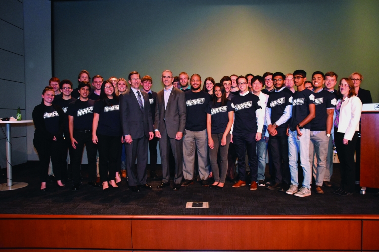Steve and Dr. Wayne H. Goodman, Aerospace executive vice president, gather with the 2018 summer interns for the TEC Talk event in Chantilly, VA.