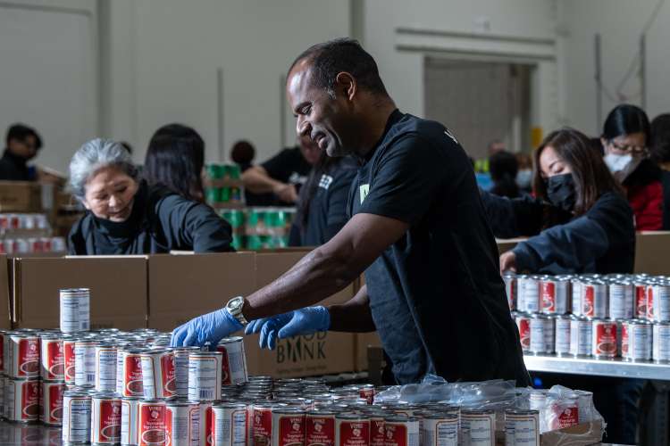 Man organizing cans at LA Food Bank.