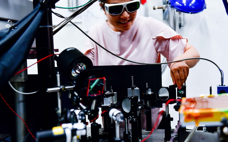 Woman sets up laser equipment