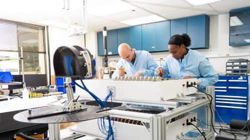 Aerospace engineers work on the mobile visible beacon in the lab