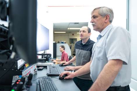 Aerospace scientists Neil Ives and Carl Boone review a rendering of an object imaged in the CT scanner.