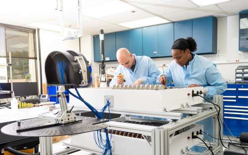 Aerospace engineers work on the mobile visible beacon in the lab