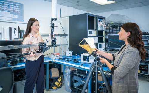 Two women having a discussion in a lab.