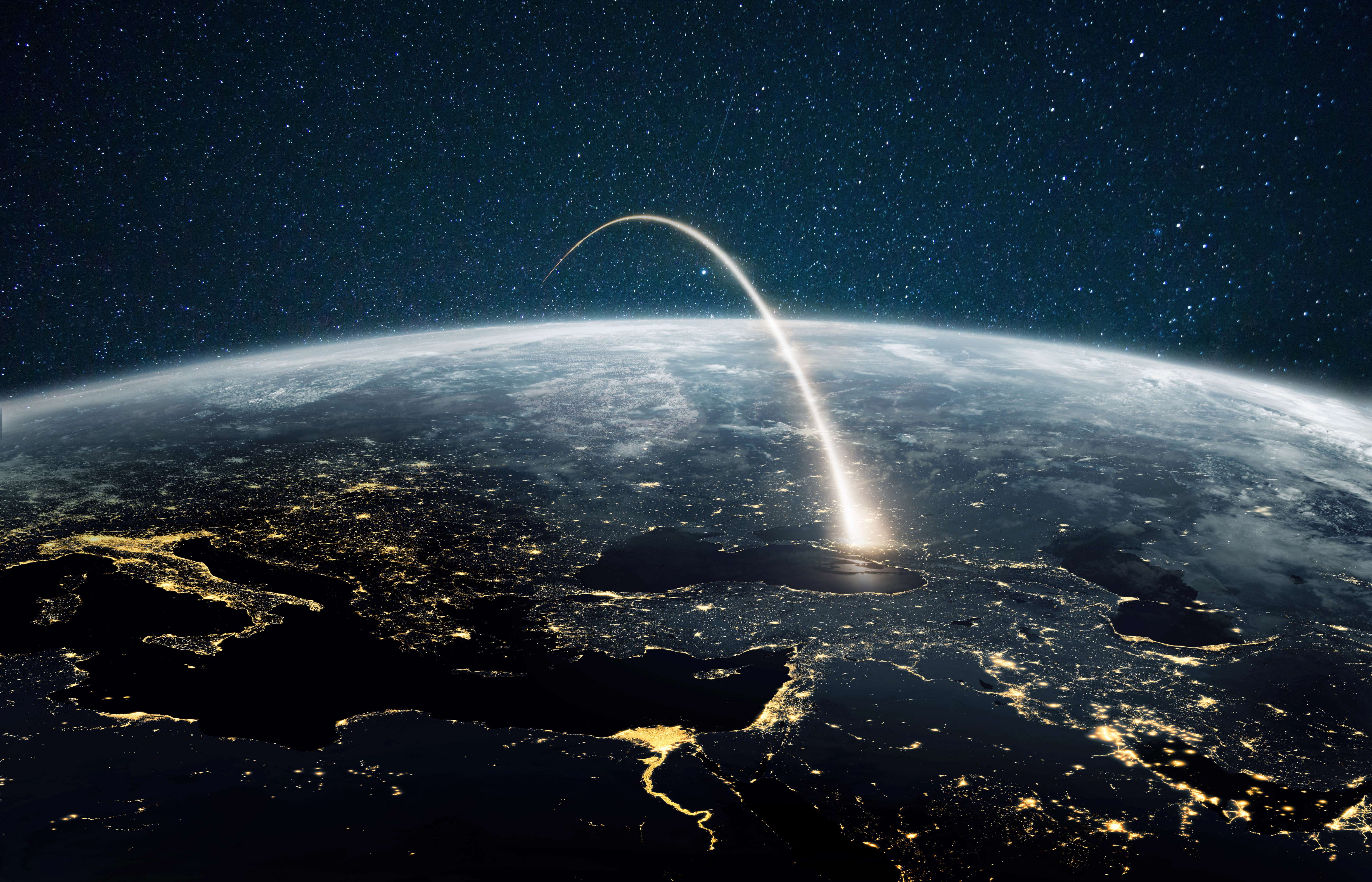 an artist's visualization of a rocket plume arcing over the earth into the stars beyond.